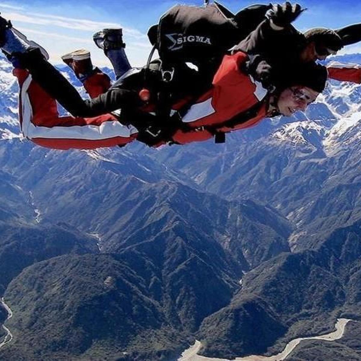 a person flying through the air on a snow covered mountain